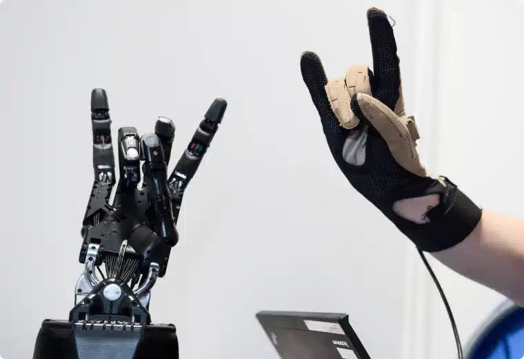 Our Story 5 A gloved Hand and the Shadow Dexterous Hand doing a rock Hand sign 🤘